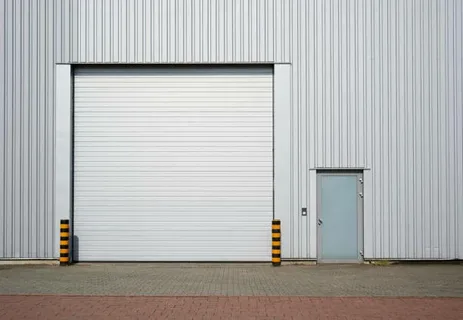 Professional technician installing automatic garage door opener on residential garage door